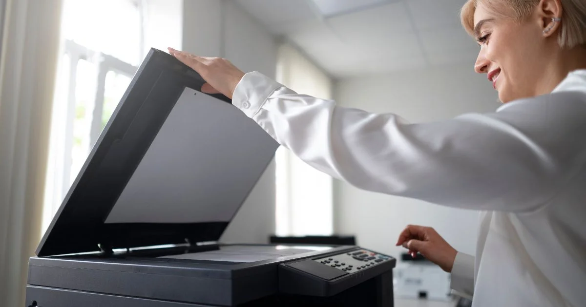 Office worker using a printer and scanner