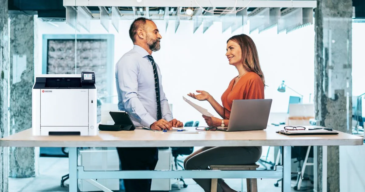 Office professionals reviewing documents and workflow solution