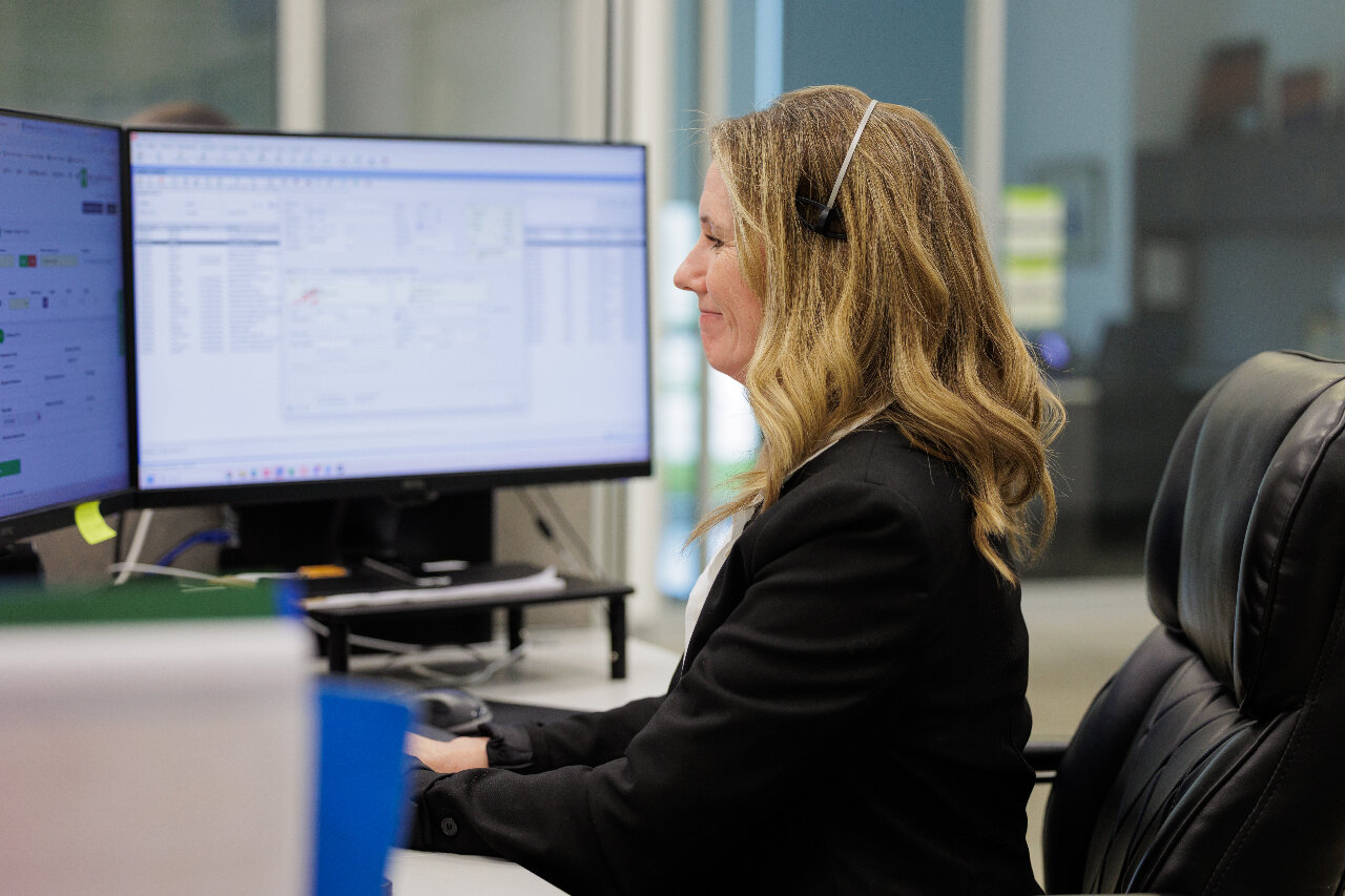 Office team collaborating around printer in modern workspace